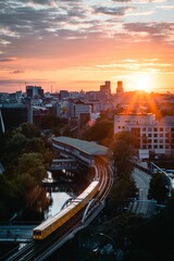 Aerial view of train on railway surrounded by buildings in Berlin during sunset