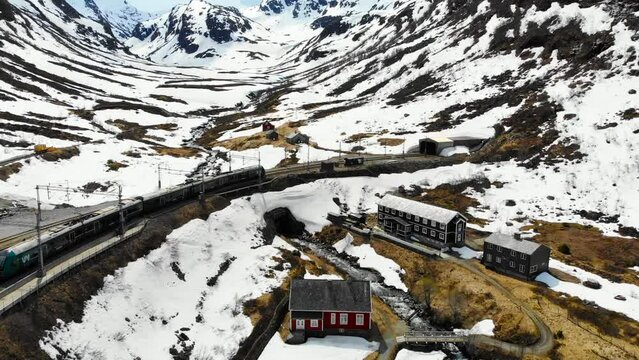 Aerial: train entering a tunnel close to Myrdal station on the Bergen line in Norway
