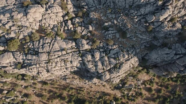Aerial drone top down shot over rocky mountain tops  in Torcal de Antequera seen from above. Karstik rocks in Spain during evening time.