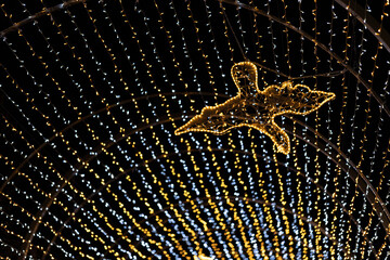 Light decorations in the park. Figures made of Christmas lights that look like gods and planets. An exhibition of decorations from Christmas lights in Poland.