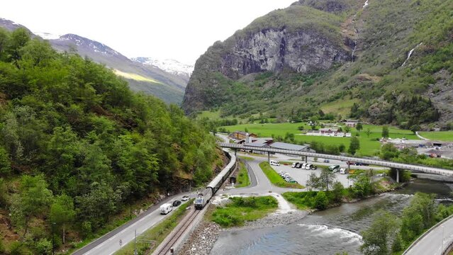 Aerial: train by a river entering to Fl&aring;m in Norway