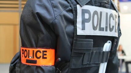 "Police" inscrit sur le brassard et sur le dos d’un uniforme de policier français (France)