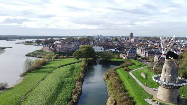 Aerial slow movement around cityscape Gorinchem surrounded by buildings and water