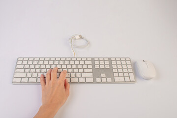 Closeup of business woman hand typing on laptop keyboard with mouse