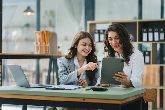 Young colleagues discussing business and price chart analyzes business people on the table great in modern coworking office teamwork concept.