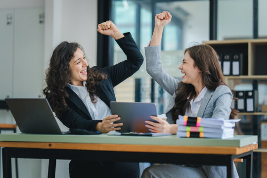 young women working together hands together teamwork Smiling happy and excited at her work.