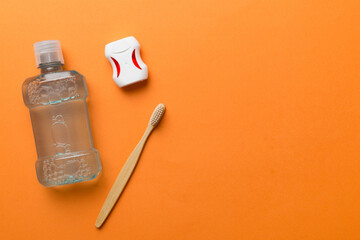 Mouthwash and other oral hygiene products on colored table top view with copy space. Flat lay. Dental hygiene. Oral care products and space for text on light background. concept