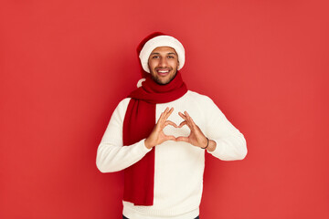 Smiling Man Showing Heart Shape Gesture. Positive Multiracial Man Holding Hands in Shape of Heart...