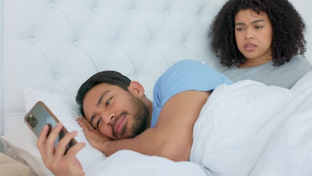 Man, bed and social media secret with phone and woman reading message, text or online post. Affair, cheating and jealous couple with no trust or faith in toxic marriage relationship in the bedroom