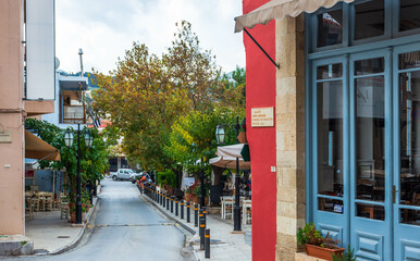  Main street with colorful buildings in Archanes.
