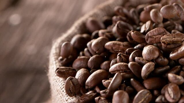 Coffee beans fall. Super slow motion at 1000 fps, filmed on high speed cinematic camera.