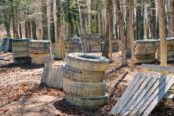 Arena for paintball sports. Fortification in the forest among walls made of wood and tires.