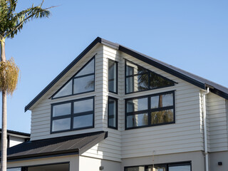 Front gable and skillion combination roof with triangle windows