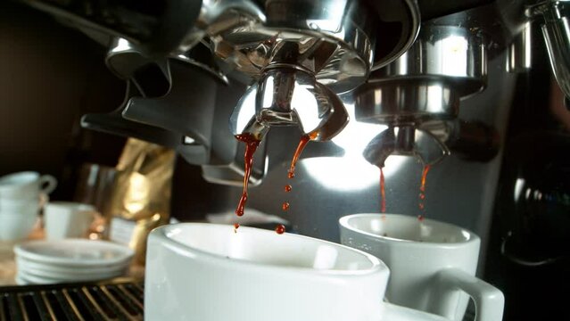 Close-up Slow Motion of Espresso Pouring from Coffee Machine. Filmed on High Speed Cinematic Camera at 1000 fps.