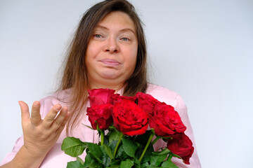 bouquet of flowers, red roses, middle-aged woman 50 years old with bulging eyes from bewilderment...