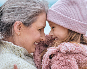 Happy senior woman, family and girl spending quality time together in the park during autumn. Cute little child and her grandmother bonding outdoor and smile with love, care and happiness in winter - Powered by Adobe