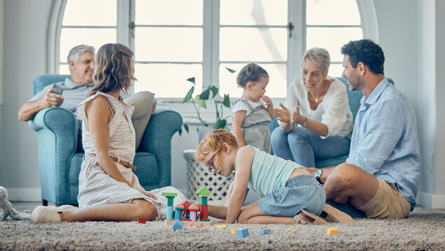 Big Family, Bonding And Children Playing In Living Room, Relax And Cheerful In Their Home Together. Happy Grandparents, Parents Smile And Enjoy Fun, Watching Kids Play On Floor While Resting On Couch