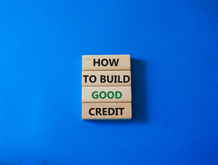 How to build good credit symbol. Concept words How to build good credit on wooden blocks. Beautiful blue background. Business and How to build good credit concept. Copy space.