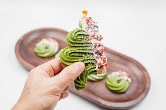 Person's Hand Holding Christmas Tree Cookie