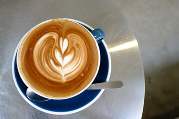 Coffee art , Latte art cappuccino coffee cup at cafe table. Closeup of Coffee art