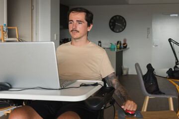 disabled man using computer, with special adaptive devices