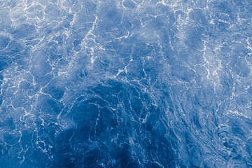 Blue purple sea surface with waves, splash and bubbles - 543418157