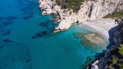 Fototapeta premium Aerial view of turquoise blue Mediterranean water on the coast of Samos, Greek Aegean Sea