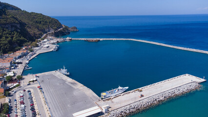 Aerial footage of shipyard in Karlovasi, Samos island behind wave breakers on a clear summer morning