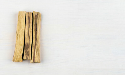 Three sticks of holy wood, Palo santo wood, isolated on white background