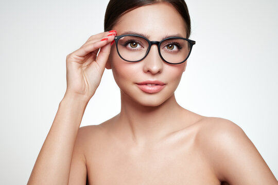 Close up of  young woman with eyeglasses on white background. Vision correction. Poor eyesight. Spectacle frame. Makeup, cosmetics, beauty