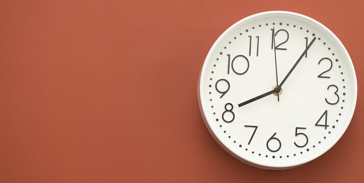 Clock on a red background, the concept of time management, time planning. Web banner, free space.