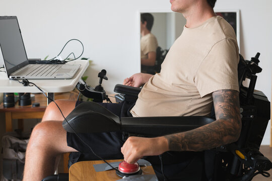 disabled man using computer, with special adaptive devices