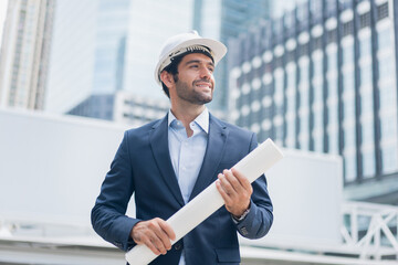 Man engineer standing on construction site. Engineer working on outdoor project