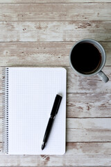 Coffee, pen and blank notebook - concept, objectives and plan of action, new year