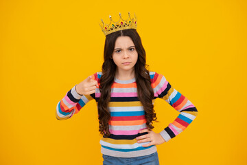 Portrait of ambitious teenage girl with crown, feeling princess, confidence. Child princess crown on isolated studio background. Unhappy sad teenager girl.