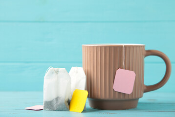 White ceramic mug with teabag label on blue background