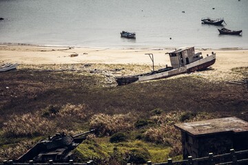View of the old, rusty boats on the beach