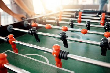 People hands, foosball table and competition in arcade with retro games, soccer action board and...