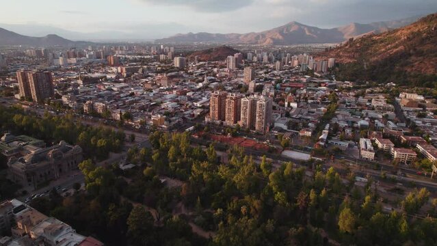 Parque Forestal Glowing Sunrise Santiago City Buildings And Streets Metropolis Over Skyscrapers Under Andes Mountains