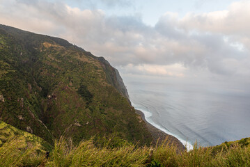 Atlantic ocean with beach and steep hills above in northwest part of Madeira