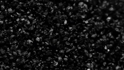 Black sand moving. Close-up of a black sand surface moving.