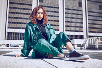 Fashion, city and gen z portrait of girl resting on outdoor floor of urban building in New York. Youth, edgy and young woman in town with retro and sporty 90s clothes style relaxed on ground.