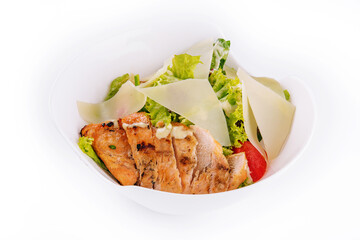 Delicious fresh Caesar salad in bowl on white