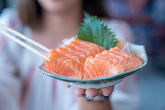 Japan raw salmon slice or salmon sashimi in japanese style. Salmon sasimi on hand.
