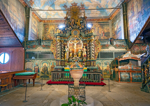 view onto the altar and a baptismal font in the baroque Lutheran wooden Articular church in Kežmarok(Kesmarok), Slovakia