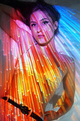 Colourful projection from beamer or slide projector onto young woman