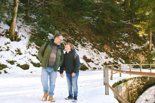 Outdoor portrait of happy father and young son walking and laughing family, acive healthy lifestyle