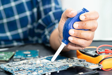 Technician use  air blower ball to clean dust in circuit board computer. Repair upgrade and...