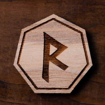 The runes are lying on a wooden table. Large rune Raido