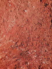 organic texture of volcanic and rocky soil with red hue